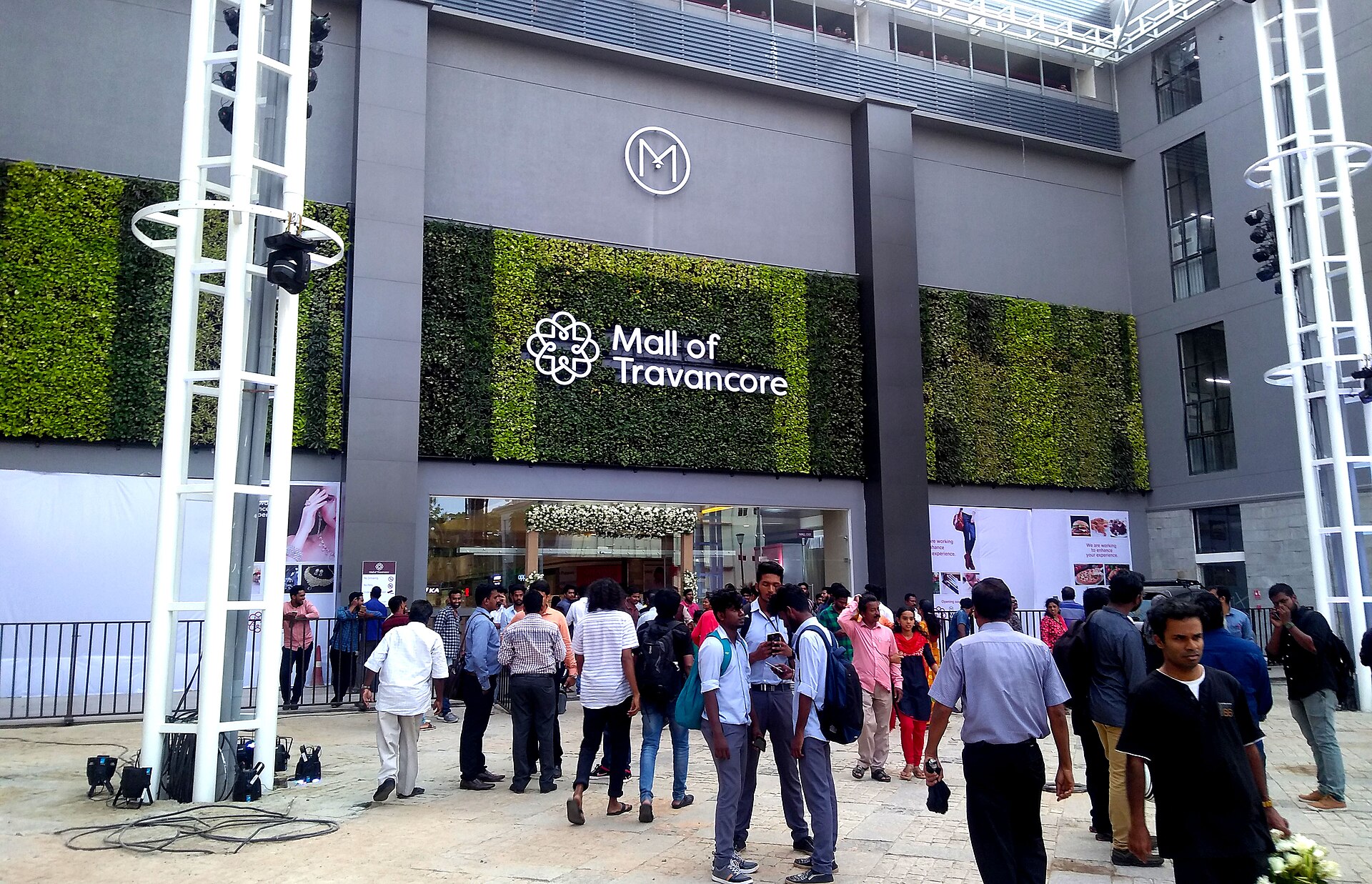 The green wall and light towers at the Mall of Travancore entrance in Chacka.