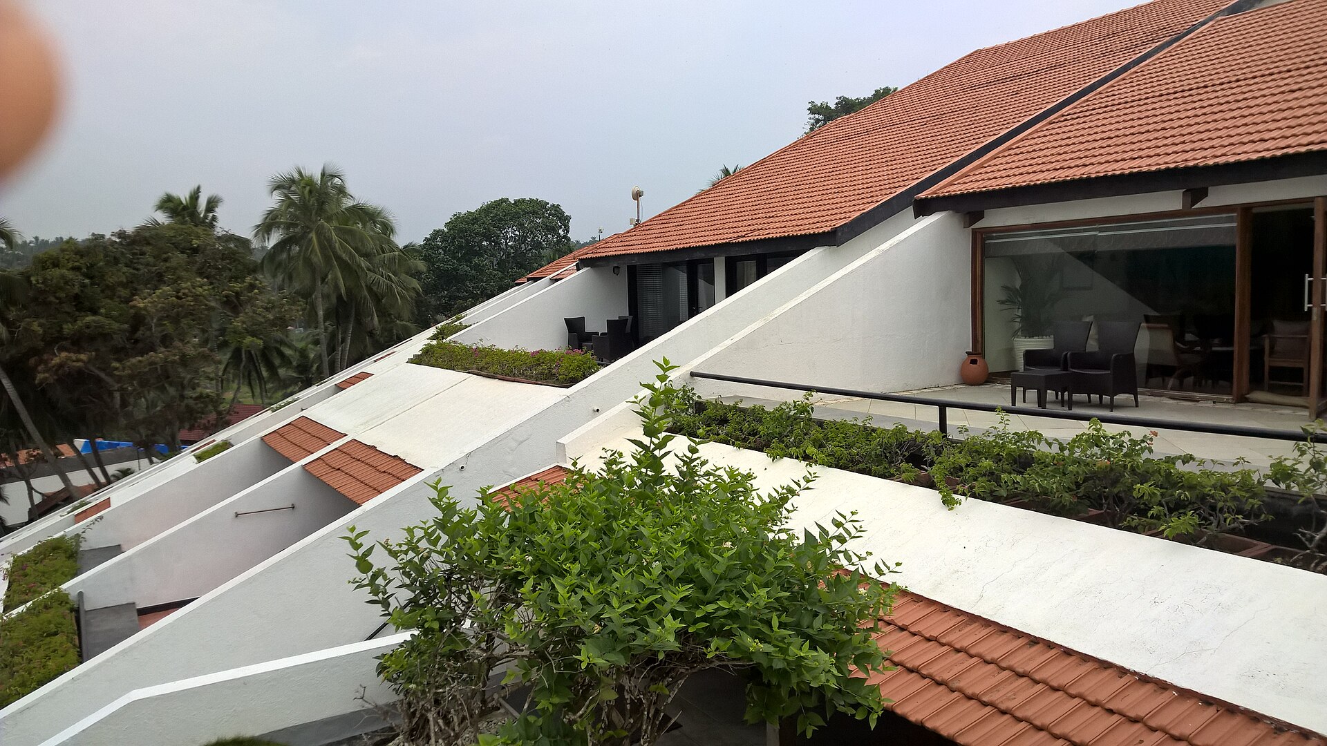 The terraced rooms of The Leela Kovalam cascading down the cliff to the sea.